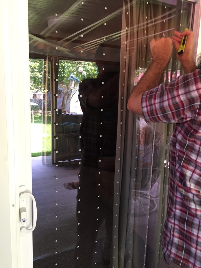 DIY Tape (outside view) small white squares of tape in a pattern on a sliding glass door
